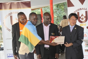 Rwanda's Tumukunde receives his certificate from Jeff Lin.