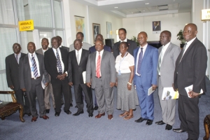 Minister Byabagambi poses for a group photo with CAA Top Management and other guests.