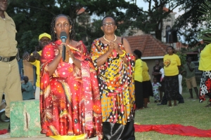 Hon. Tumusiime kneels to thank her supporters.