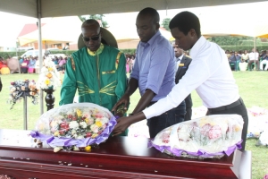 Gen. Tumwine and his kids lay their wreath.