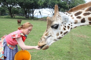 Madeline feeds giraffe.