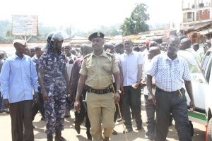 RPC Kaheebwa with a cane. He quelled the brewing violence together with his fellow cops.