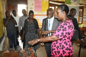 Hon. Tumusiime appreciates some of the crafts made by the pupils.