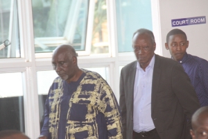 Rose Tumusiime's dad Robert Bikaako (L) and Chris Kahirita entering the court room.