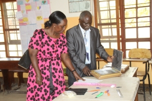 The Calvary Chapel Christain School Head Teacher Pastor Stanley Mayanja show cases some of the crafts that the pupils do.