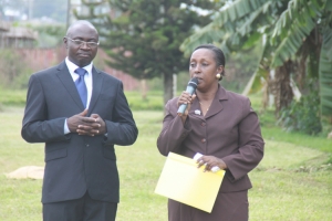 Hon. Tumusiime addressing the TASO Members as the Centre Manager Robert Kadando looks on.