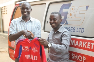 Kiweewa Lawrence poses for a photo with Veracles Coach. Veracles Sports Academy will brand their kits with the S&S Logo.