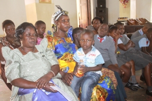 Late Okiror's Widow Milly Okiror with Kid in somber mood.