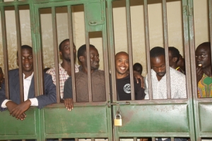 The NRM youth leaders smiling behind court cells.