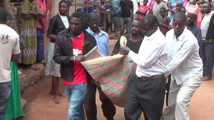 Locals carry the deceased body.