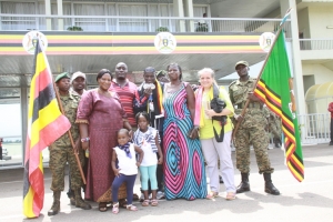 titus-tugume-in-black-shades-poses-for-a-group-photo-with-his-mumin-maroon-dress-relatives-and-coach-corinne-hafner-matovu