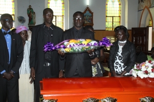 Late Abongomera's kids lay a wreath on his casket.