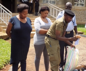 Afande Emilliane Kayima parades two female drug traffickers at the Entebbe Airport  Aviation Police head quarters at who were arrested with illegal possession of narcotic drugs in November 2016. 