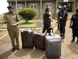 kmp-publicist-emilliano-kayiima-parades-the-four-bags-containing-cocaine-before-the-media