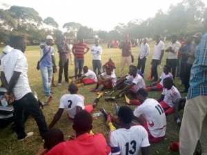 Coach Moses Vivalavie (white cap) talks to his Katabi-Kitubulu players during half time. Katabi Kitubulu beat Bugonga 12-11 on penalties.