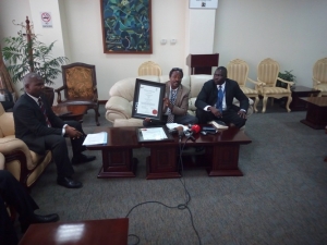 Eng. Kagoro John unveils the ISO Certificates that were awarded to CAA.