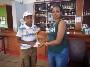 John Musiimenta recieves his trophy from Entebbe Club Lady Captain Jovia Tugume.