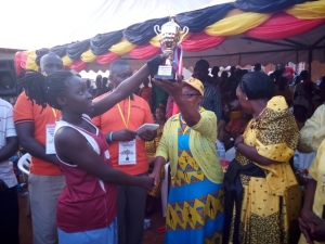 Katabi Busambanga Captain receives trophy from Municipal Council Speaker Peninah Kasaija.
