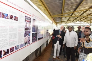 President Museveni looks at the architectural design for the Hospital.