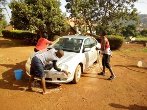 Youth from the HIV/AIDS Global Fund Organisation participate in a car washing exercise at St. Padre Pio Catholic Parish Church in Bwebajja.