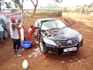 Youth participate in a car washing campaign at St. Padre Pio Catholic Parish Church in Bwebajja.