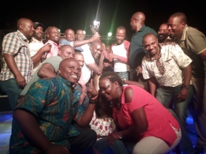Entebbe club jubilate with trophy at the 19th hole.