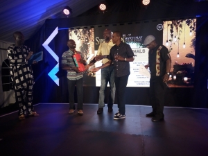 Entebbe Club Vice Chairman Oscar Semawere receives the fire extinguisher from Kiryowa Kiwanuka and Elly Mukasa.