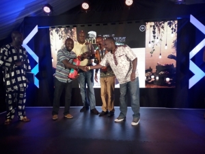 Nuwagira Collins and Dan Kajungu donate their Fire Extinguisher to Entebbe Club Vice Chairman Oscar Semawere.