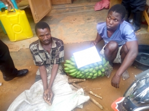 Abbas Bywkwaso (L) and Fideri Muhindo (R) at Mpala Police Station with the Matooke and Cassava they stole.