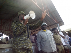 Maj. James Nuwagaba addresses the fishermen. He urged the fishermen to handover the illegal fishing gear.