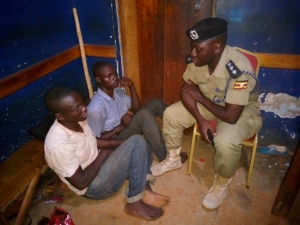 OC Mpala Joseph Sekitoleko interrogating the two thugs shortly after they arrived from Gulu where they were detained.