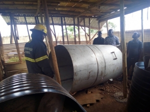 Plain cloth security officers disconnect the boiler that was to be used in the mixing of the chemicals.