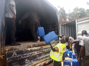 Porters load the chemicals onto a Police truck.