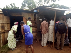 Residents gather around the Kiosk where Late Peninah Namusisi was found dead.