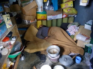 The deceased lying dead in her congested Kiosk. A charcoal stove was discovered inside the kiosk.