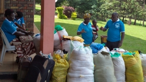 Cate Okurut and Bishop John Okware pray for relief items before they were flagged off to Gulu and Arua on Thursday