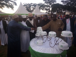 MP Tumusiime joined Muslims in cutting a cake to celebrate Eid Day.