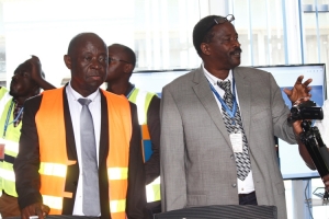 CAA MD Dr. David Kakuba (L) and Director Airports John Kagoro explain to the media on the newly established Emergency operations Center.