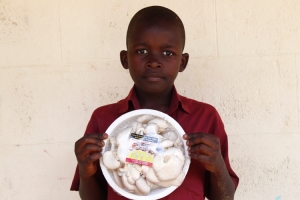 Moses Mukisa Kasirye displays packaged mushrooms ready for sale.