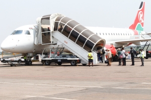 Passengers board a Kenya Airways flight. Tanzanian Precision Airways resumed flights at Entebbe Airport while Qatar Airways upgraded from A320 to A330 operating at Entebbe Airport.