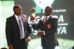 Paul Baite receives the Migingo Cup on behalf of Team Uganda from UGU President Johnson Omollo.
