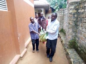 Residents lift Nampala Sarah's body to the Police truck.