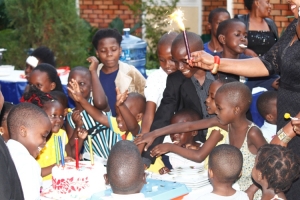 Roy with other kids cut a confirmation cake.