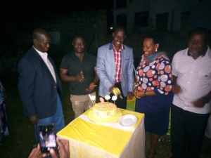 SFC's Kamugira Mcdans with wife cutting a cake during his welcome back party.