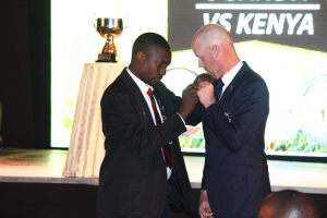 Team Uganda Coach Amos Kamya Decorates Team Kenya Coach John Van Leaf Land.