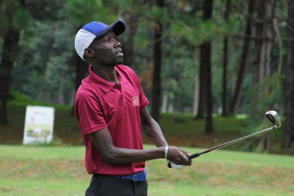 Uganda's Ronald Rugumayo watches his ball during day 2 action at the Victoria Cup in Entebbe. Kenya leads 9 points to Uganda's 7 going into tomorrow's final round of Singles. Photo by Timothy Okiror.