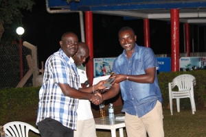Entebbe Club Chairman Dr. Twinemanzi hands over a castle lite prize to Andrew Baguma who won the August Golf Mug tournament. 
