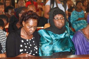 Grace Otim with veil thanked everyone who stood with her when her husband was hospitalized.