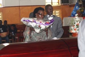Jancitha Rutimbirayo lays a wreath on her Late husband's casket.