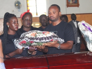 Late Rutimbirayo's children lay a wreath on their Late Father's casket.